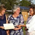 Older same sex married ladies receiving marriage certificate from celebrant